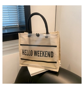 Detail of PVC printed panel with Hello Weekend text and linen tote bag texture