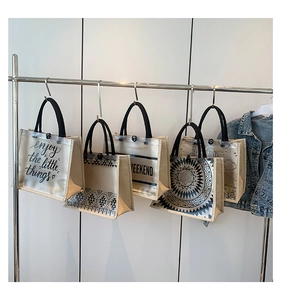 Detail view of printed canvas tote bags with PVC stitching and various graphic designs