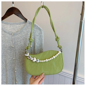 Detail of avocado green pleated bag with silver heart charms and pearl chain strap