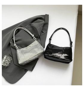 Detail of silver and black sequin baguette bags with knot handle for evening parties