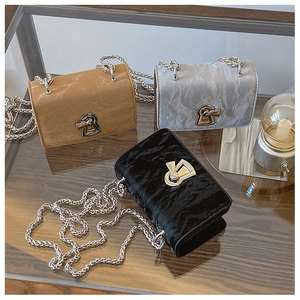 Three pleated chain shoulder bags in brown grey and black with geometric metal locks