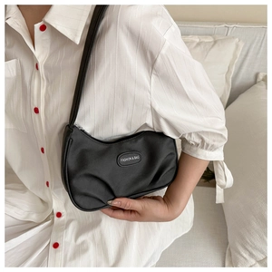 Detail of black crescent hobo bag with Fashion & Bag logo and pleated texture