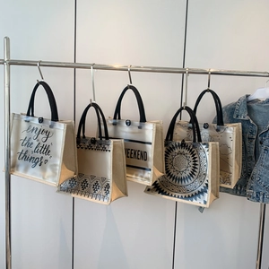 Chic transparent tote bags with printed canvas designs and black shoulder straps