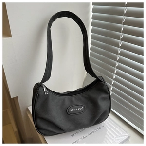 Close-up of black nylon crescent shoulder bag with fashion leather patch detail