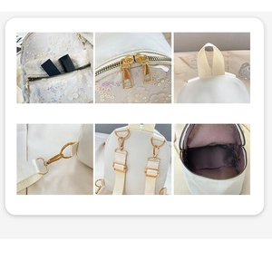 Detailansicht weißer Paillettenrucksack mit 3D-Blumen, goldener Zipper und Stauraum