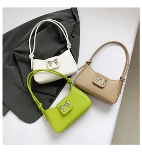 Detailed view of women's shoulder bags in white, green, and khaki with butterfly hardware