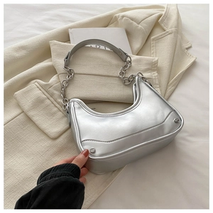 Detail of silver metallic hobo bag featuring chain strap and sleek minimalist finish