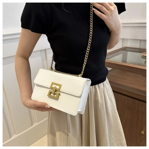 Chic white square crossbody bag with gold geometric buckle and chain strap on model