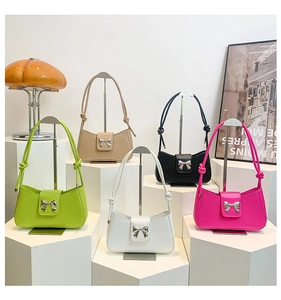 Chic women's underarm bags in five vibrant colors with butterfly metal buckles
