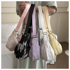 Detailed group view of colorful nylon shoulder bags with contrast stitching and embroidery