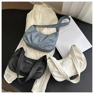 Detailed trio of pleated hobo bags in black, beige, and blue with fashion logo hardware