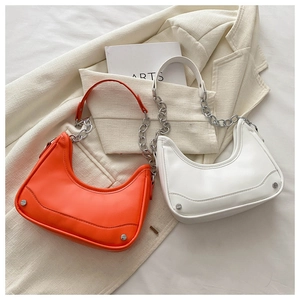 Detail of hobo bag with leather strap, silver chain and rivets in orange and white