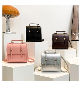 Detailed display of mini faux leather backpacks in pink, black, brown and silver colors