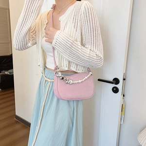 Pink half-moon shoulder bag with decorative pearl and silver heart chain for women
