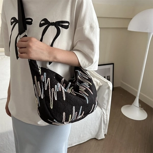 Fashionable black crescent shoulder bag with colorful embroidery and wide nylon strap
