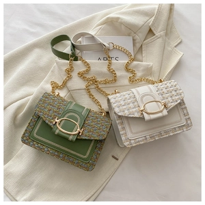 Close-up of elegant tweed and PU leather crossbody bags with gold chain and U-buckle detail