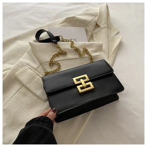 Macro detail of high-quality black leather texture with a gold geometric metal buckle