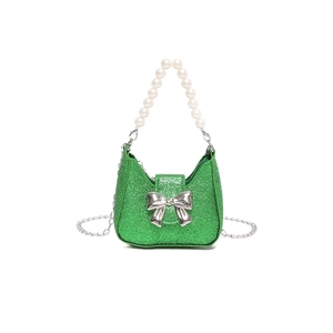 Bright green sequin handbag with pearl handle and silver bow accent in studio lighting