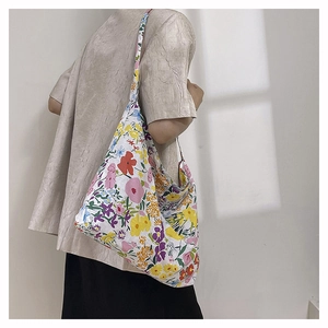 Detail view of floral print tote bag with vibrant hand-painted patterns on canvas