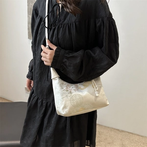 Modern Chinese style large cream shoulder bag with floral embroidery and tassel details