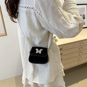 Elegant black velvet mini crossbody bag with silver butterfly and metal chain strap