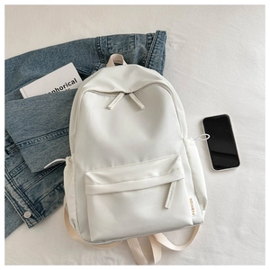 Detailed top view of white Oxford fabric backpack with side drawstring pockets and labels