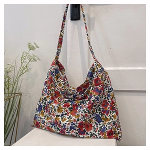 Detail of floral tote bag showing vintage cotton fabric and long shoulder strap design