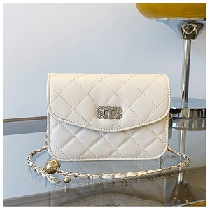 Detail of quilted off-white crossbody bag with silver chain and adjustable metal ball