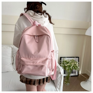 Detail of pink fashion backpack with front zipper pocket and adjustable side drawstring