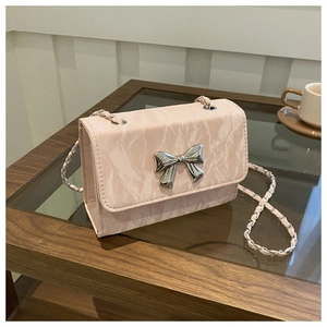 Detailed close-up of pink marble pattern faux leather handbag with silver butterfly buckle