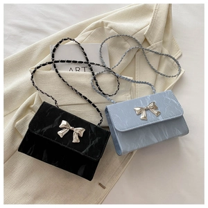 Detail of mini crossbody bags with marble texture and silver butterfly buckle