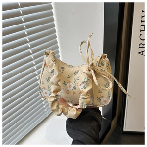 Close-up of yellow floral tote bag with ruched handle and side bow detail decoration
