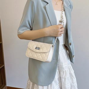 Classic quilted crossbody bag in cream with adjustable gold chain and ball buckle