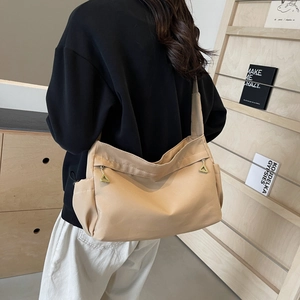 Minimalist beige shoulder tote bag with triangle zipper and practical side pockets
