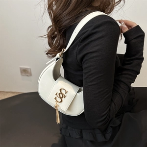 Elegant white leather crescent bag with gold monogram metal buckle and long tassel charm