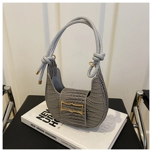 Detailed view of grey crocodile pattern hobo bag with gold hardware and knot handle