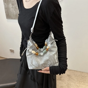 Sac seau chic marbré avec texture en soie et anse perlée pour un port à l'épaule élégant