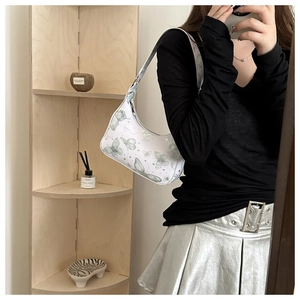 Detail of white butterfly print hobo bag in glossy PU leather with silver zipper