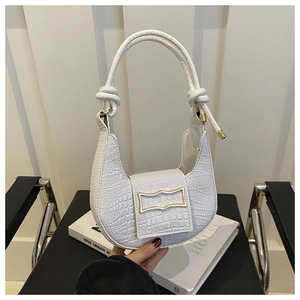 Detail of white crocodile pattern shoulder bag with a stylish gold buckle and knot handle