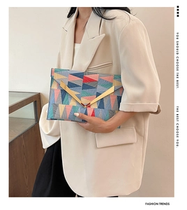 Detailed close-up of fashion envelope clutch featuring colorful geometric triangle patchwork