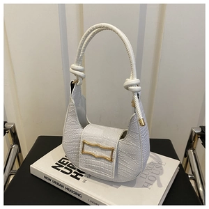 Detail of white crocodile embossed hobo bag with gold metal buckle and knotted handle