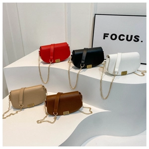 Detail view of five saddle bags in red, black, white, beige, and dark brown colors