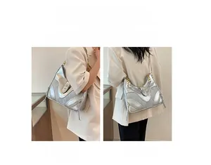 Silver metallic bag detail with chain and fringe, showing single shoulder and crossbody styles