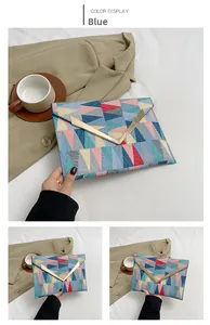 Detailed view of blue geometric color block clutch with elegant gold V-shaped buckle