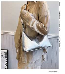 Detail view of silver shoulder bag with crinkled leather effect and metallic finish