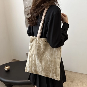 Champagne gold velvet tote bag with leaf embossing in a vintage shoulder style