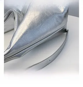 Close-up of silver textured shoulder bag showing metallic finish and pleated details
