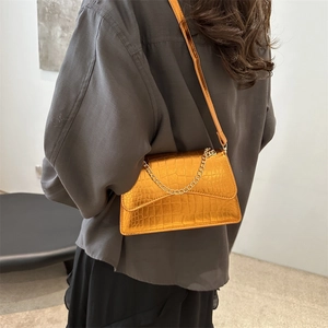 Chic metallic orange crossbody bag with crocodile pattern and elegant chain strap detail