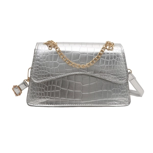 Silver crocodile pattern flap bag with gold chain strap and sleek minimalist design