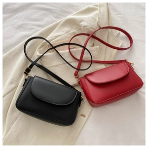 Detail of red and black matte PU leather mini crossbody bags with gold metal buckles